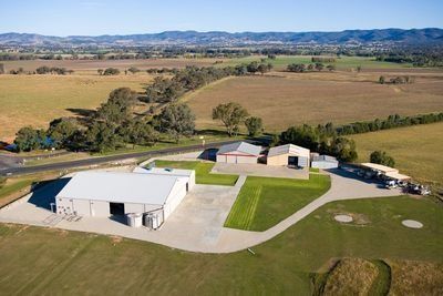 An aerial view of a farm with a lot of buildings