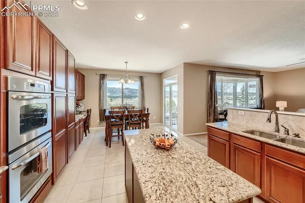 A kitchen with granite counter tops and stainless steel appliances.