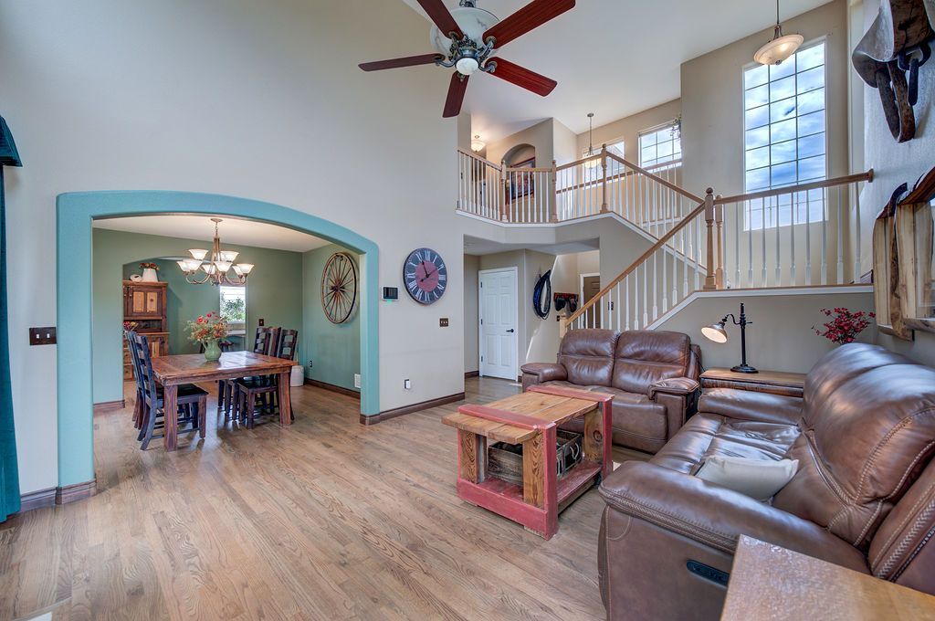 A living room filled with furniture and a ceiling fan.