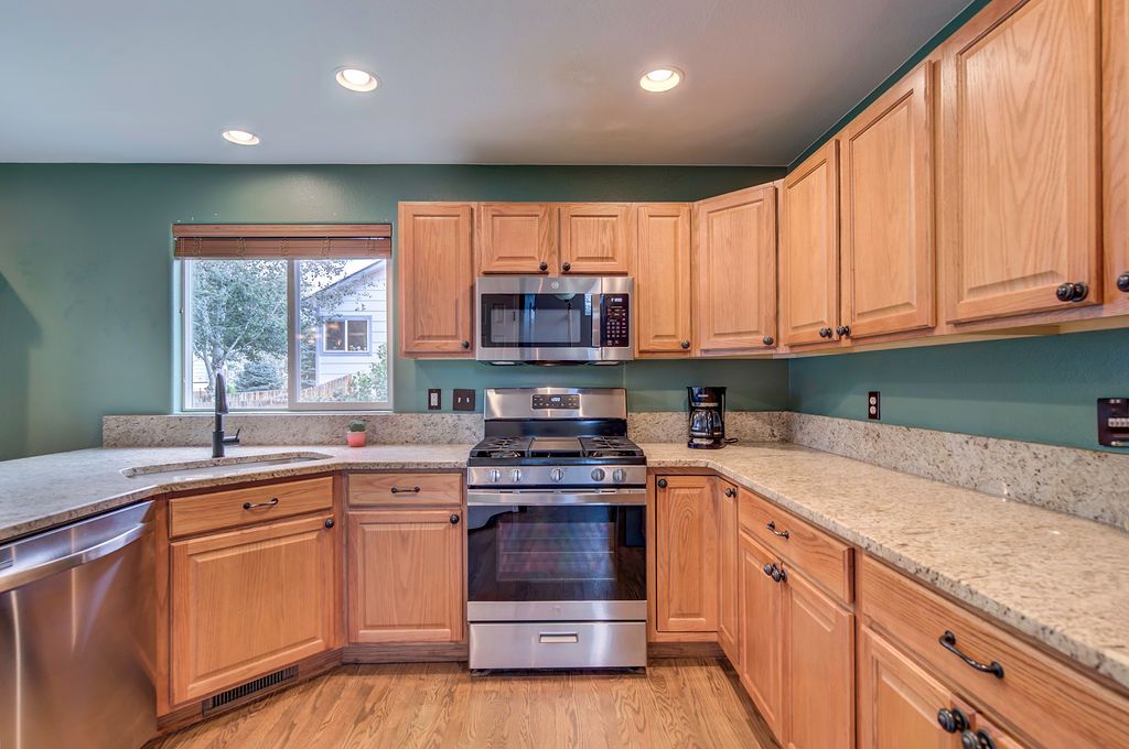 A kitchen with wooden cabinets and stainless steel appliances.