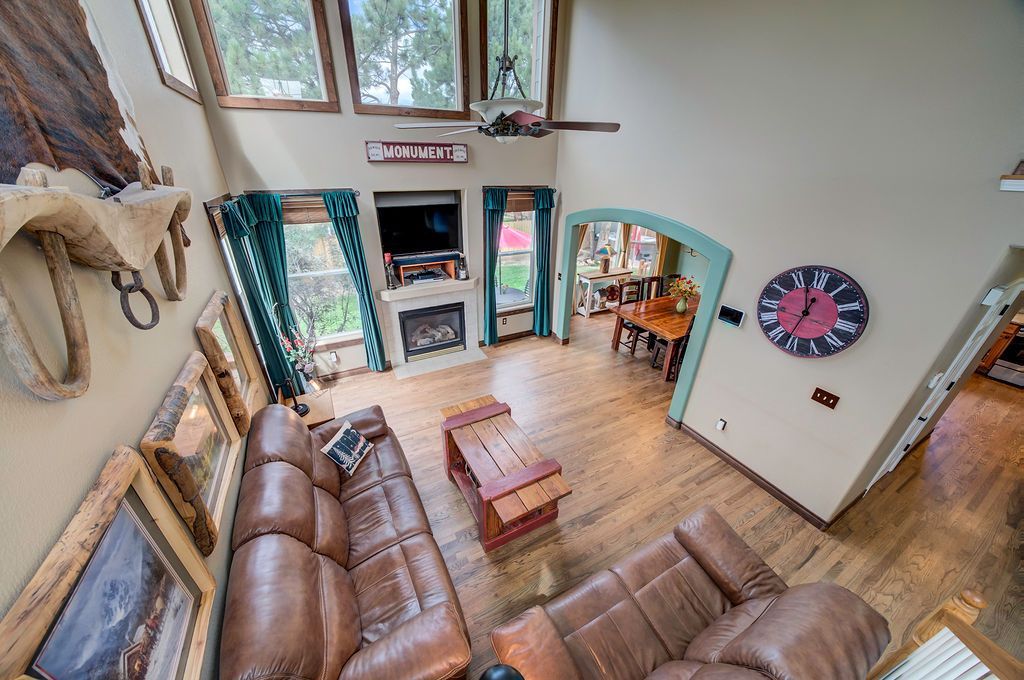 An aerial view of a living room with a clock on the wall.