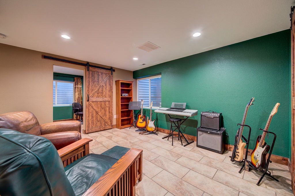 A living room filled with furniture and guitars.
