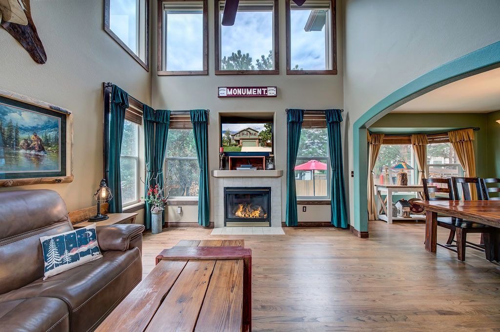 A living room with a couch , table , fireplace and television.