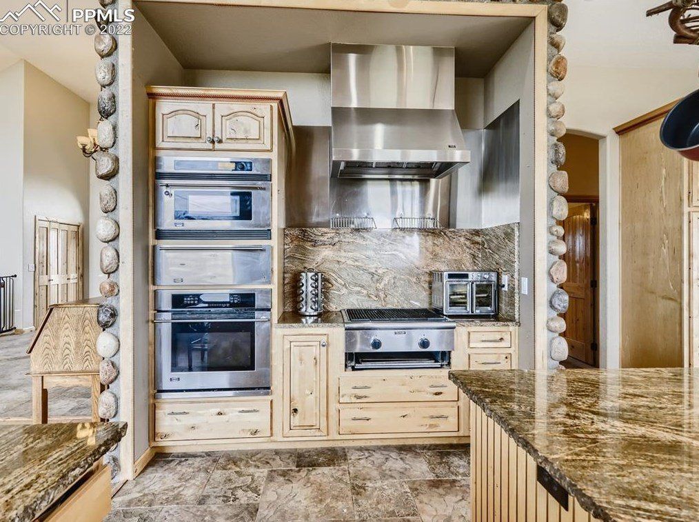 A kitchen with stainless steel appliances and granite counter tops