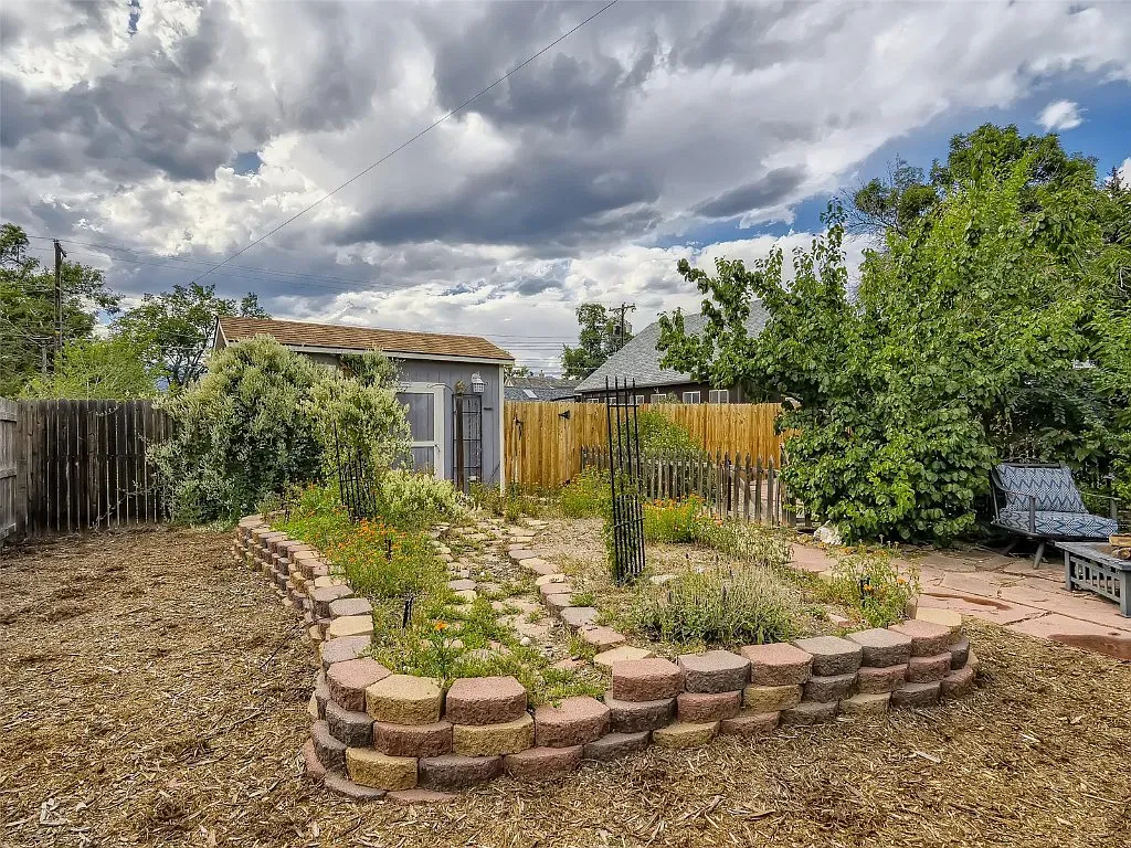 There is a garden in the backyard of a house.