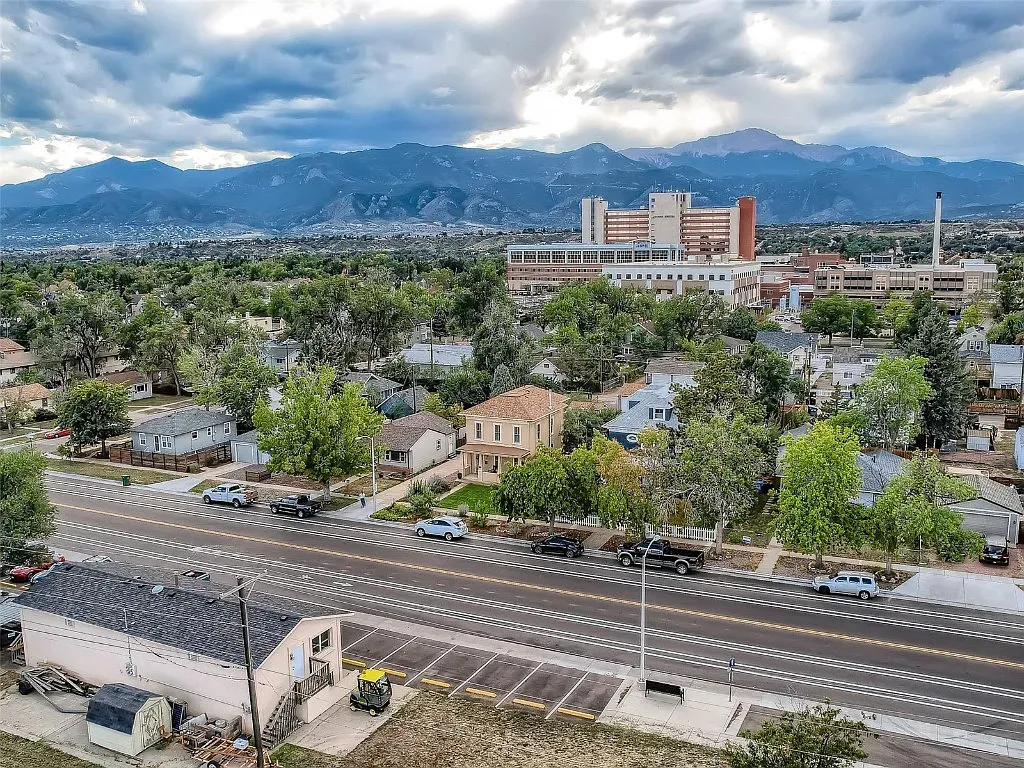 An aerial view of a city with mountains in the background.