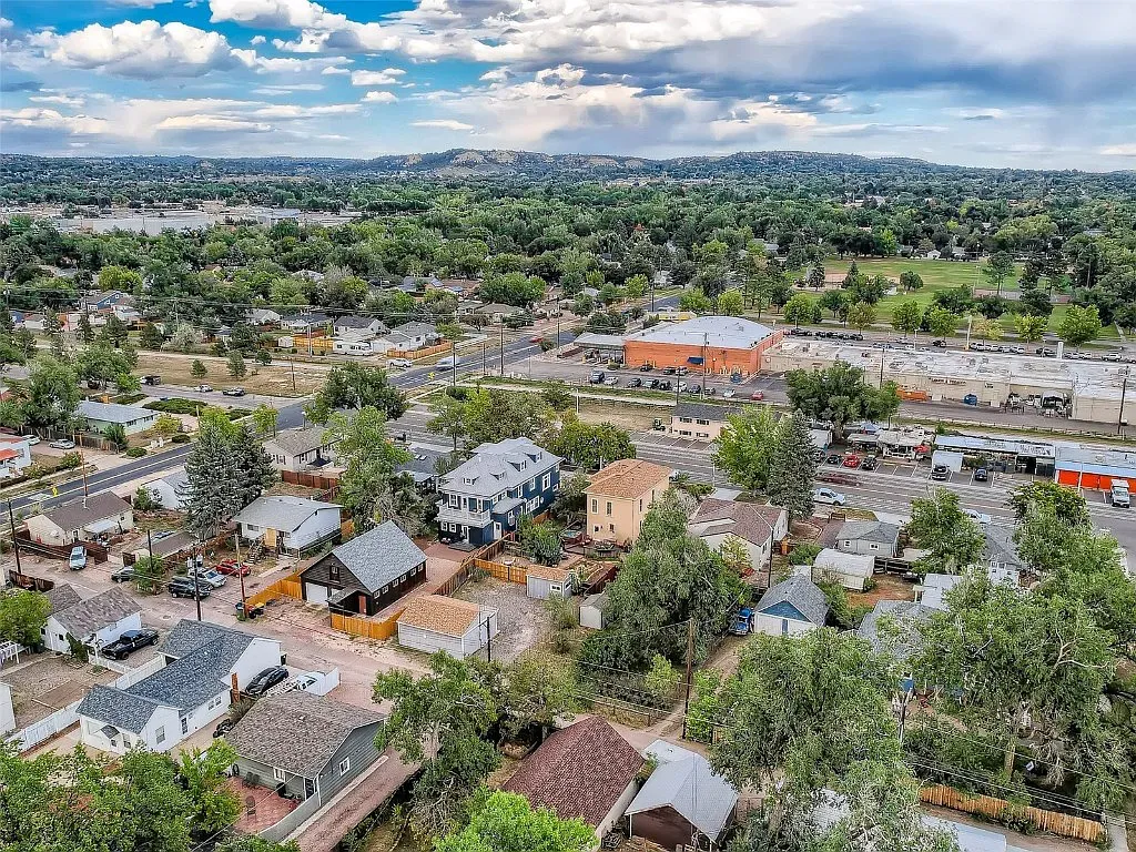 An aerial view of a small town with lots of houses and trees.