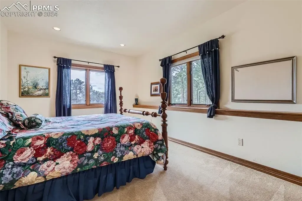 A bedroom with a large bed and a large window