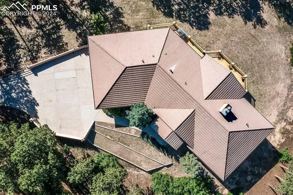 An aerial view of a house with a brown roof