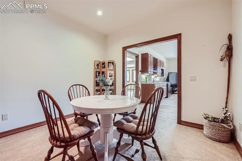 A dining room with a table and chairs in it