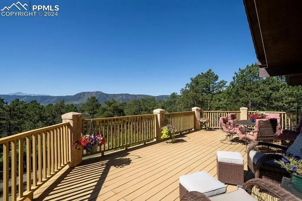 A large deck with a view of mountains and trees