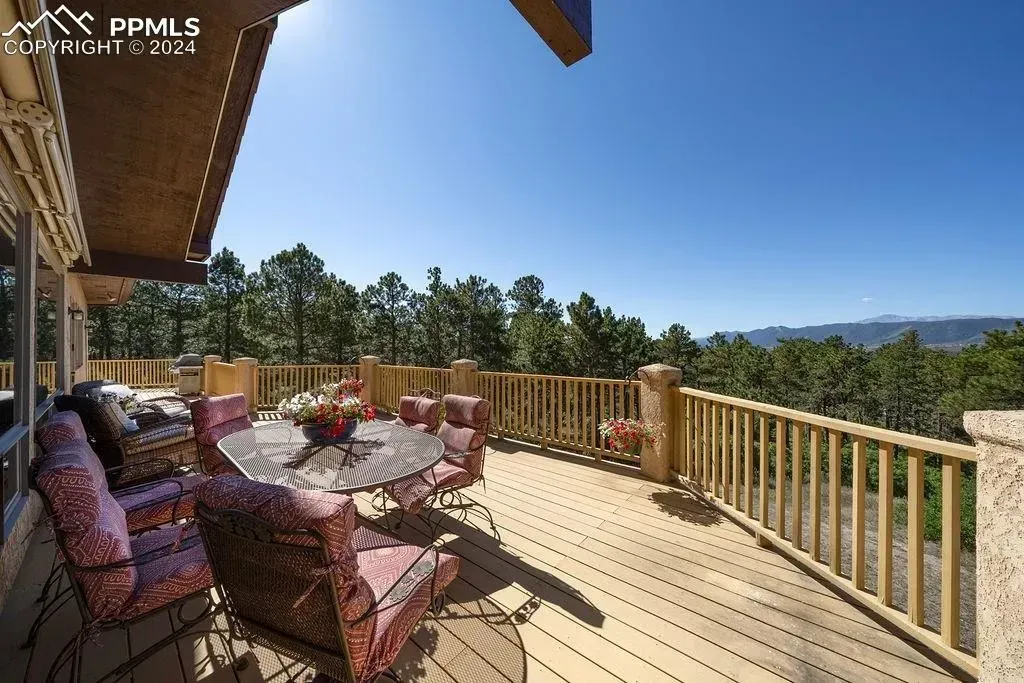 A large deck with a table and chairs on it