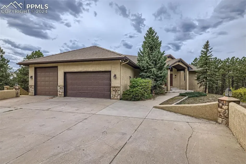 A large house with two garage doors and a large driveway
