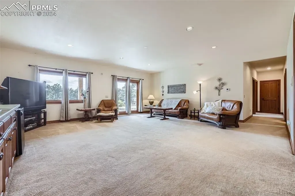 A living room filled with furniture and a television.