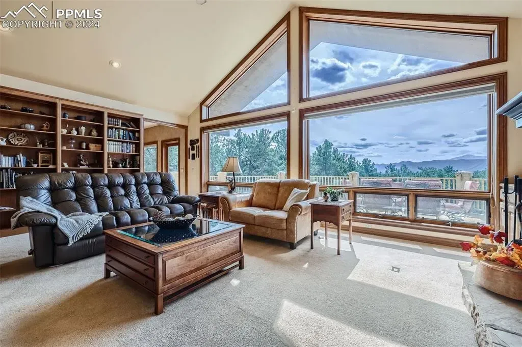 A living room with a lot of windows and furniture