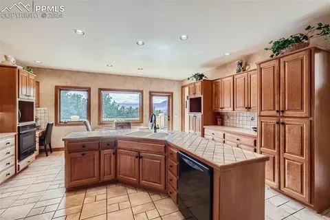 A large kitchen with wooden cabinets and a large island.