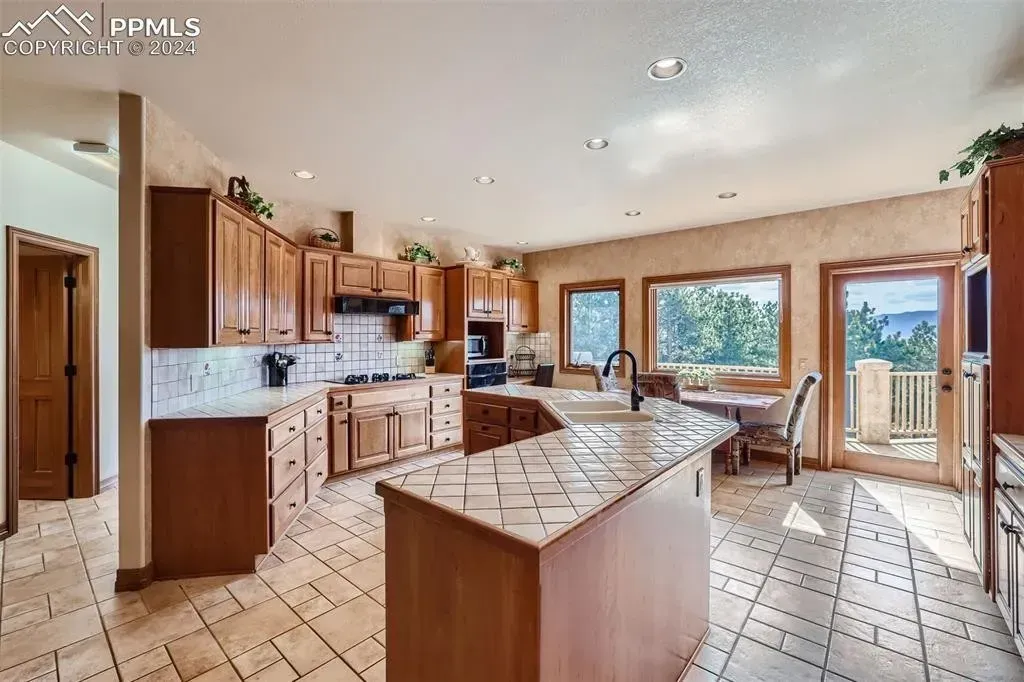 A kitchen with a large island and lots of cabinets