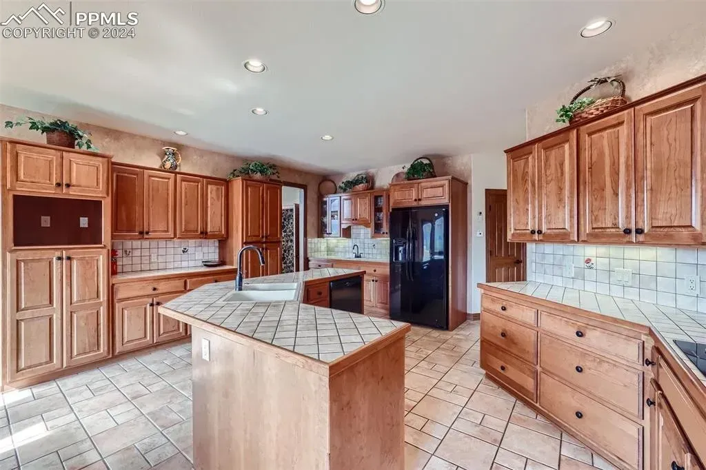 A large kitchen with wooden cabinets and a large island.