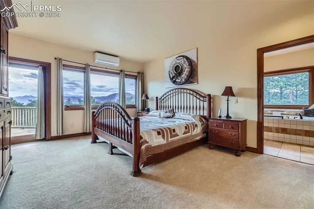 A bedroom with a large bed and a large window