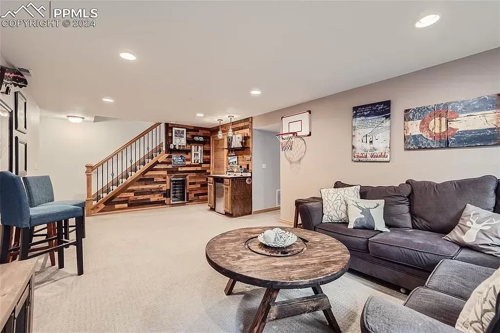 A living room with a couch , chairs , and a coffee table.