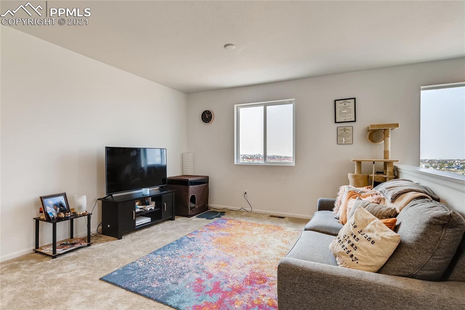A living room with a couch and a flat screen tv