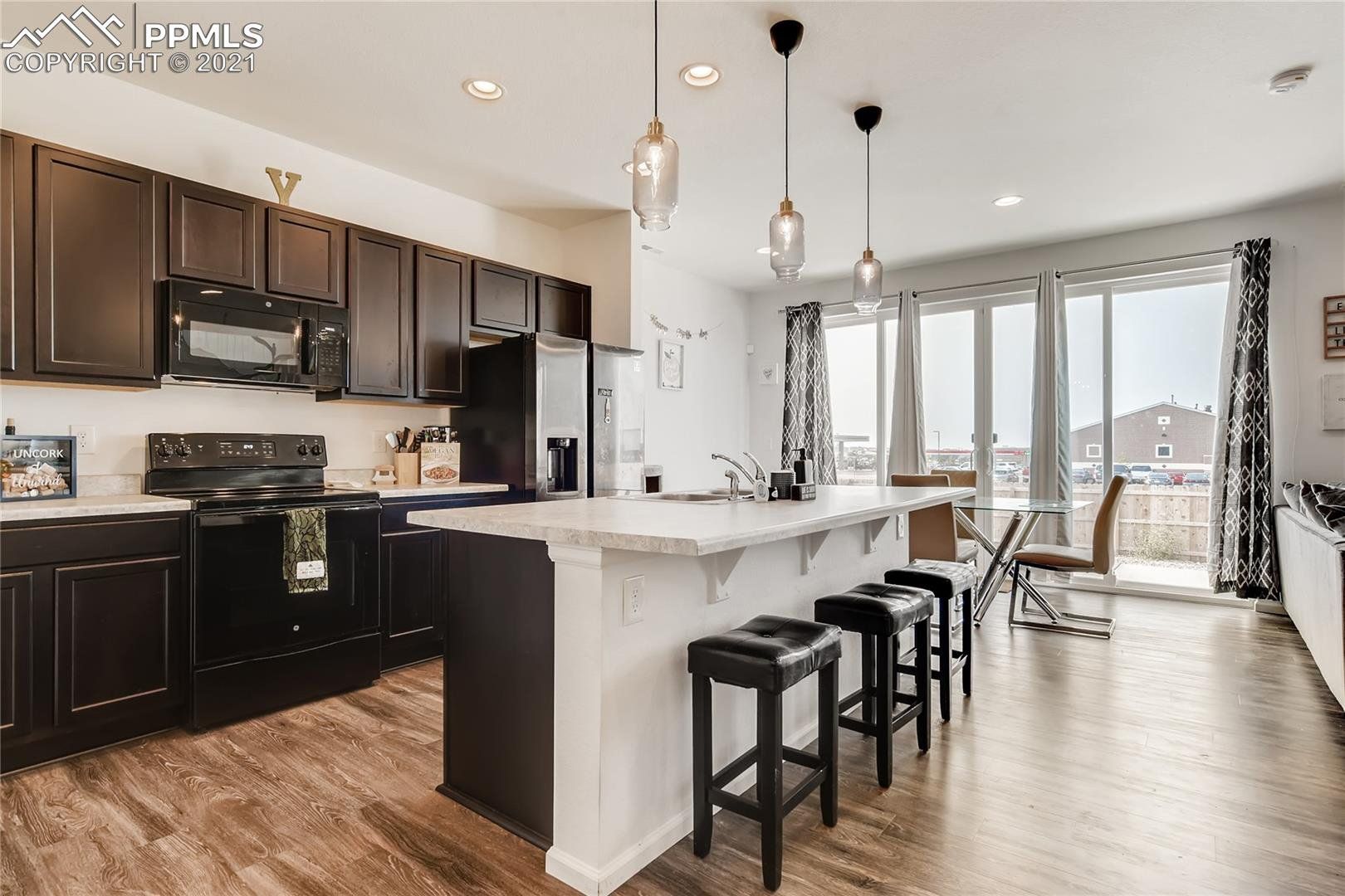 A kitchen with a large island and stools