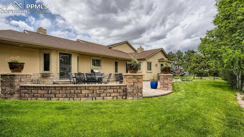 A large house with a large lawn in front of it.