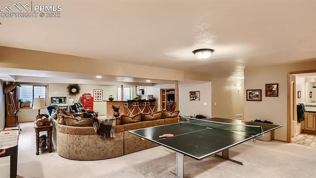 There is a ping pong table in the middle of the room.