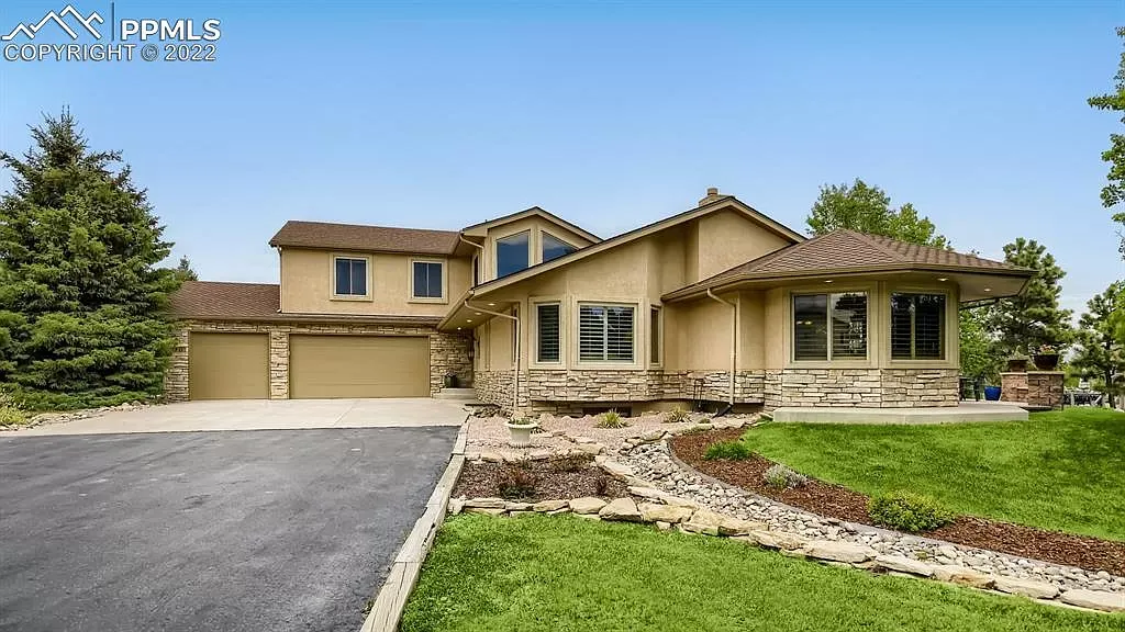 A large house with a lot of windows is for sale.