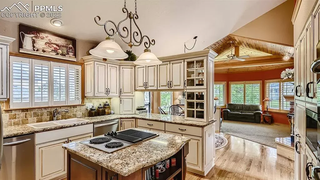 A large kitchen with granite counter tops and stainless steel appliances.
