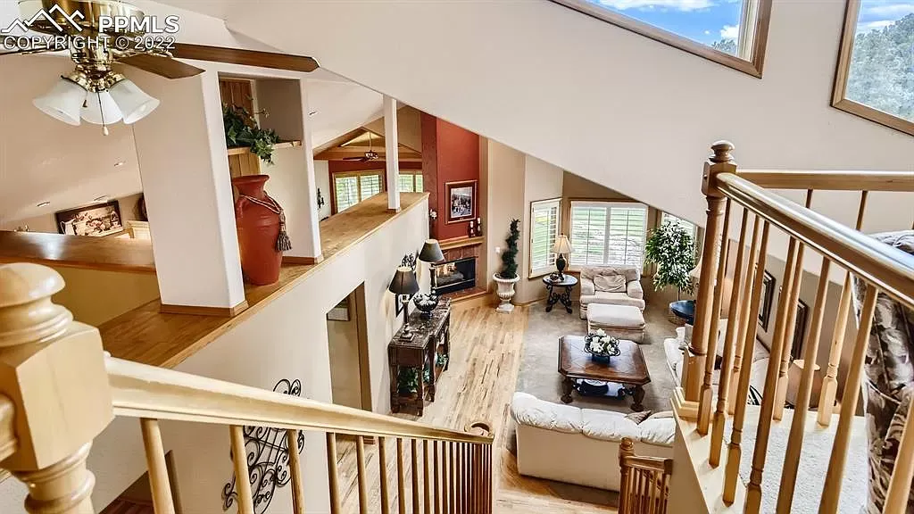 A view of a living room from the second floor of a house.
