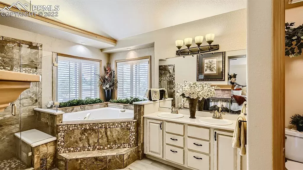 A large bathroom with a jacuzzi tub and two sinks.
