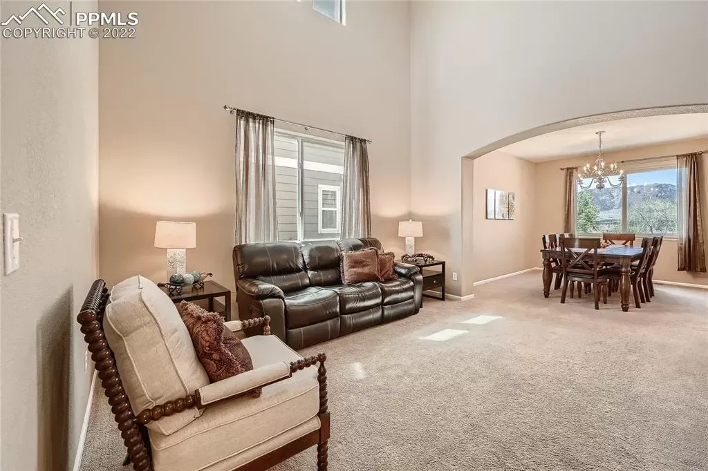 A living room with a couch a chair and a table