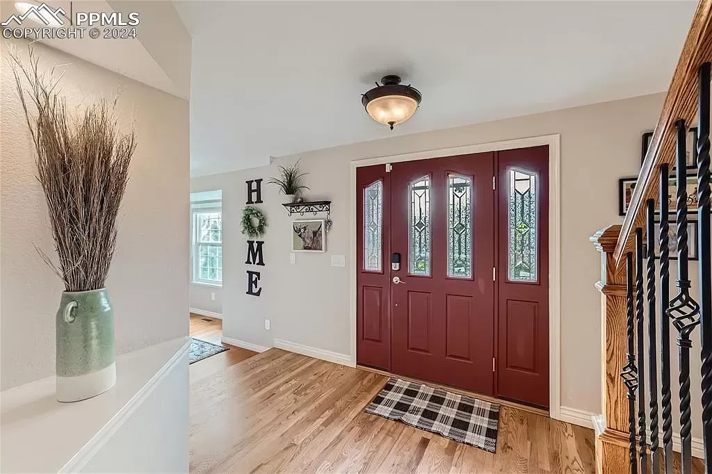 A collage of three pictures of a house with a red door and stairs.