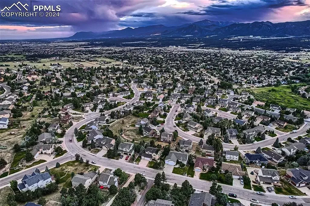 An aerial view of a residential area with lots of houses and trees.