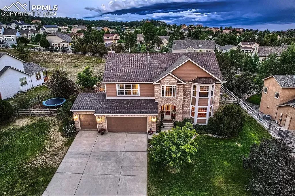 An aerial view of a large house in a residential area.