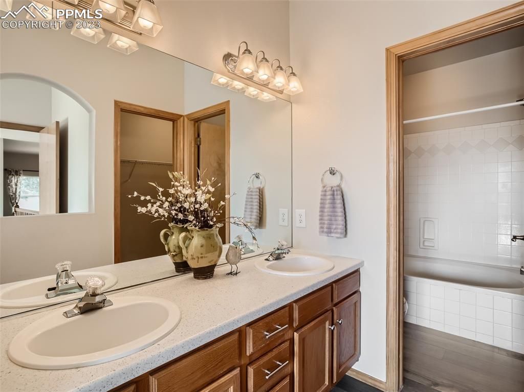 A bathroom with two sinks and a large mirror.
