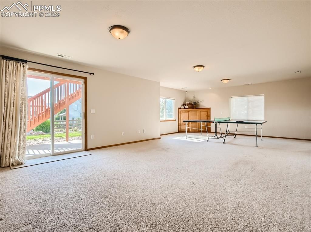 An empty room with a table and a sliding glass door