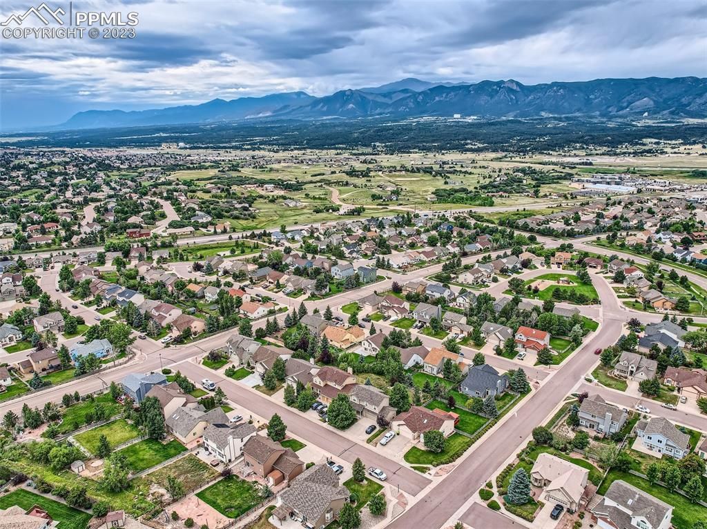 An aerial view of a residential area with mountains in the background.