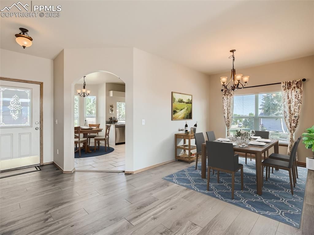 A dining room with a wooden table and chairs