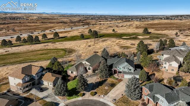An aerial view of a residential area with houses and trees.