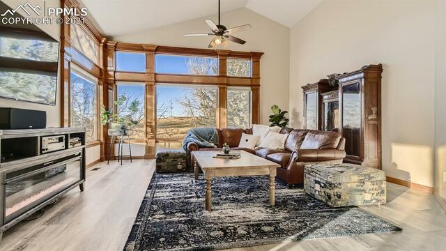 A living room with a couch , coffee table , and ceiling fan.
