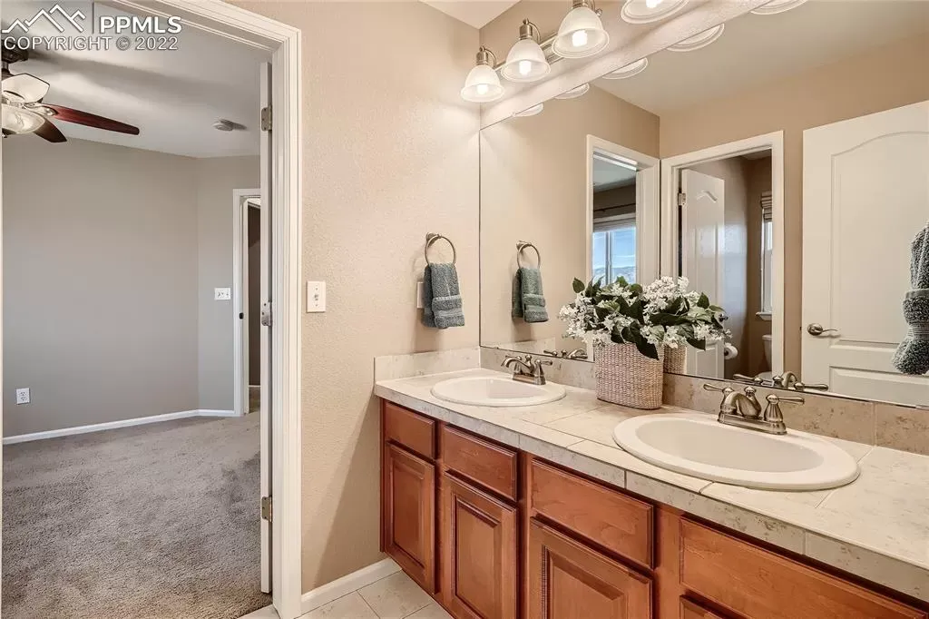 A bathroom with two sinks and a large mirror