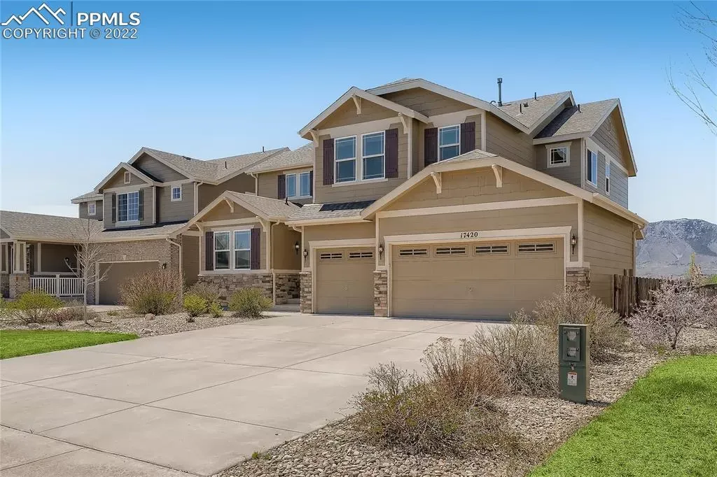 A large house with two garages is for sale in a residential area.