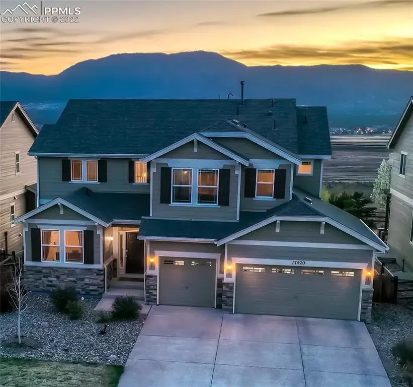 An aerial view of a house with mountains in the background