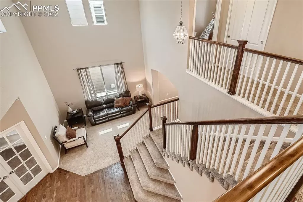 An aerial view of a staircase leading up to a living room in a house.