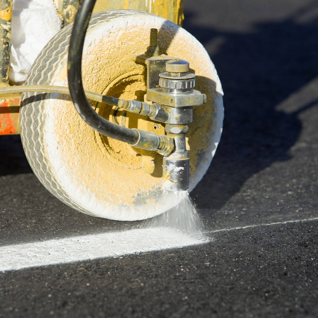 Parking lot getting striped with white lines