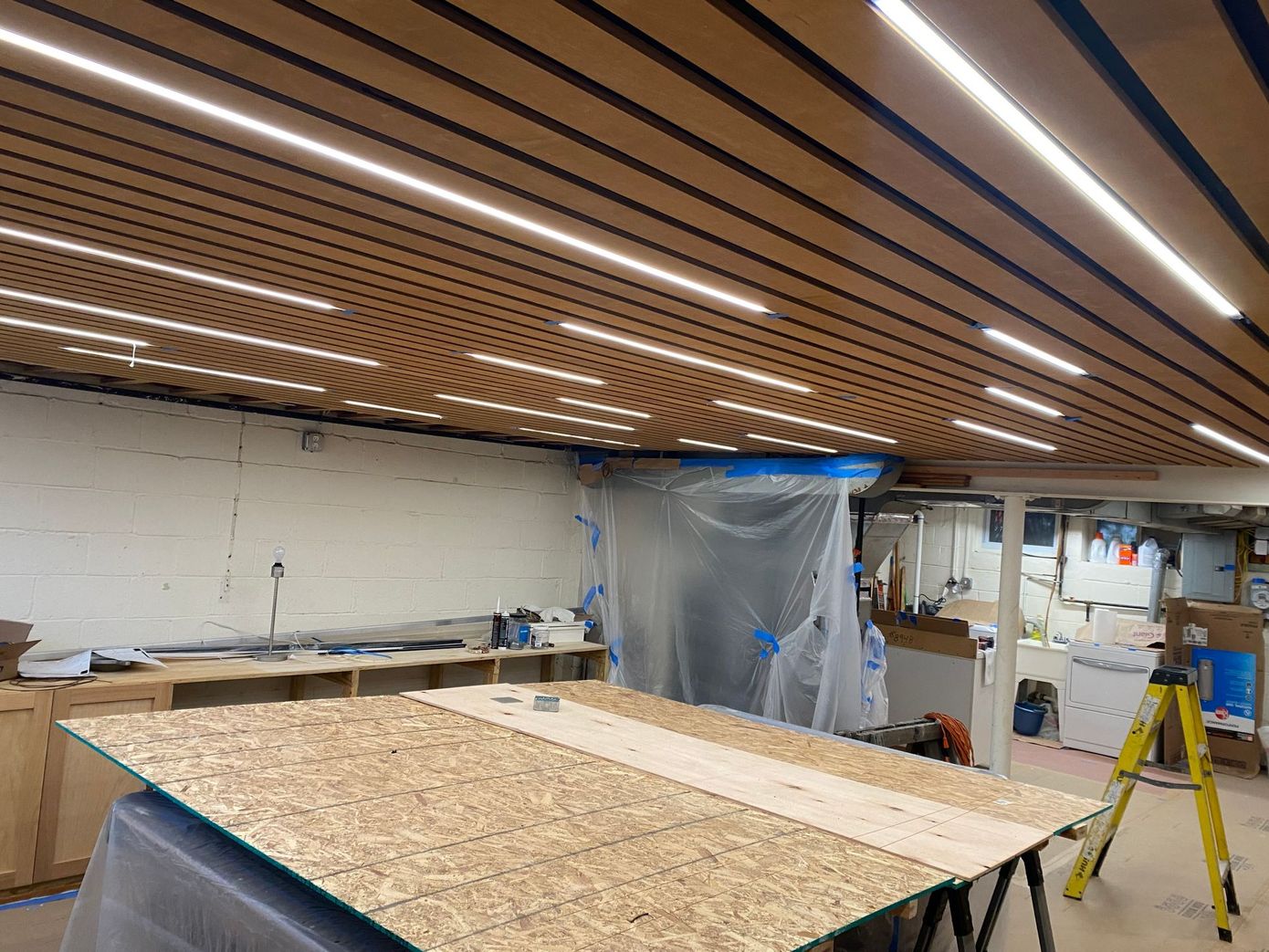 A large wooden table is sitting in a room with a wooden ceiling.