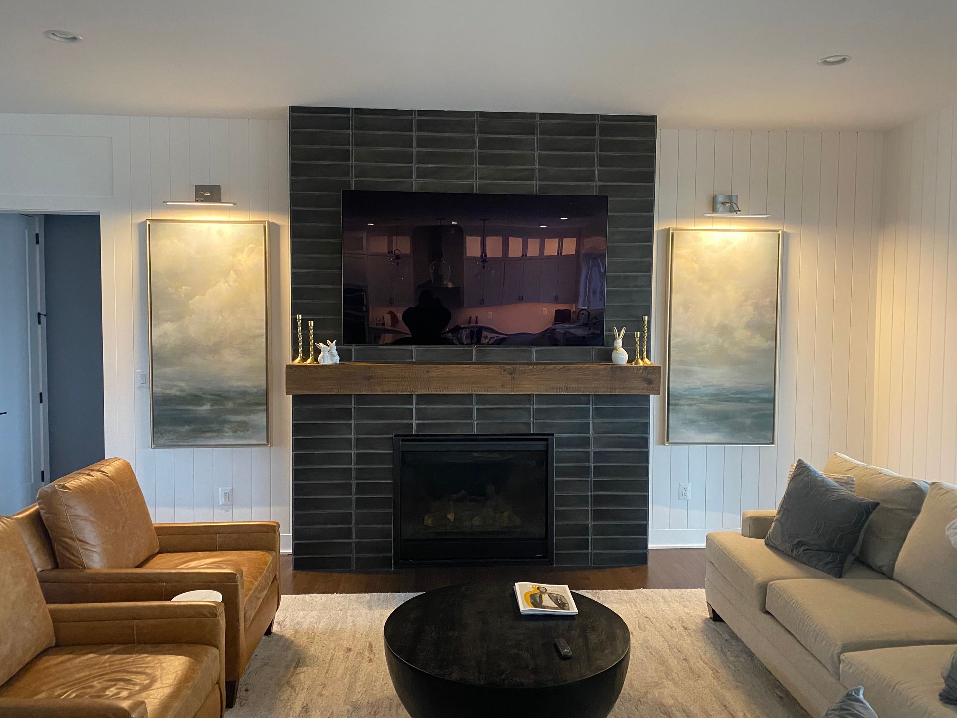 A living room with a fireplace and a flat screen tv