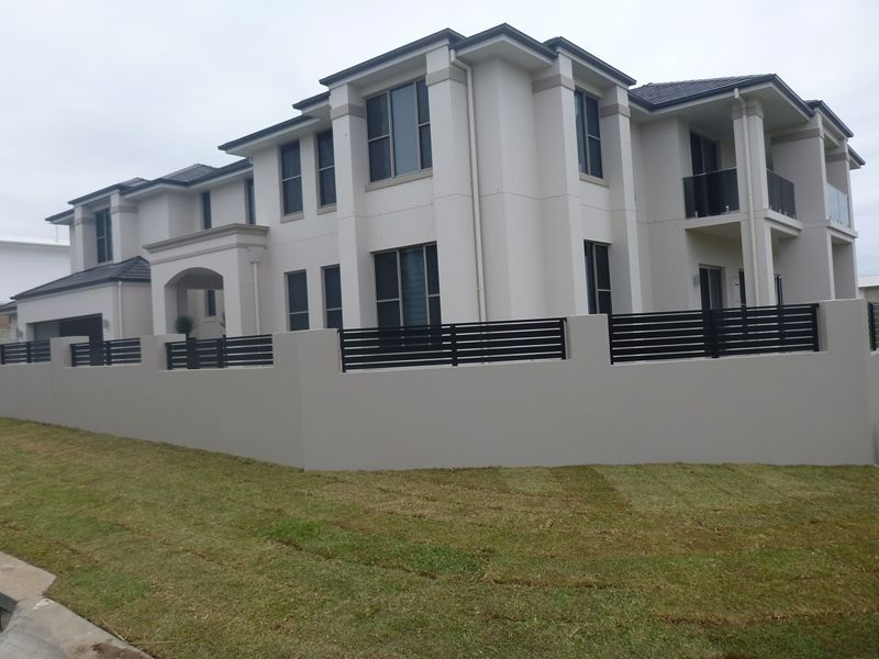 A large white house with a black fence around it